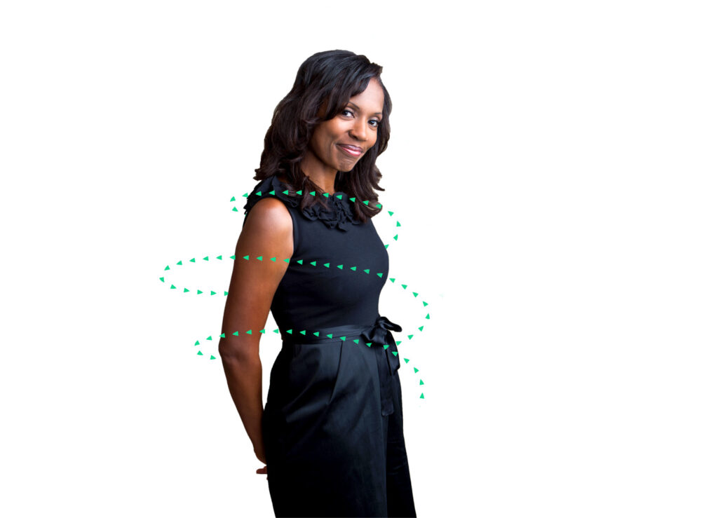 black woman in dress suit smiling with Kuvare logo arrows circling her body